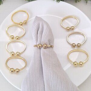 8 napkin rings gold ( I don't think it's brass )